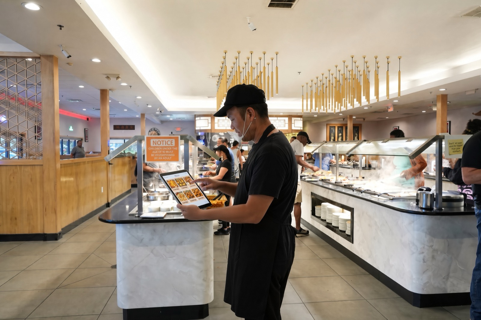 A buffet team member calling a dish on Bar Order Caller during service